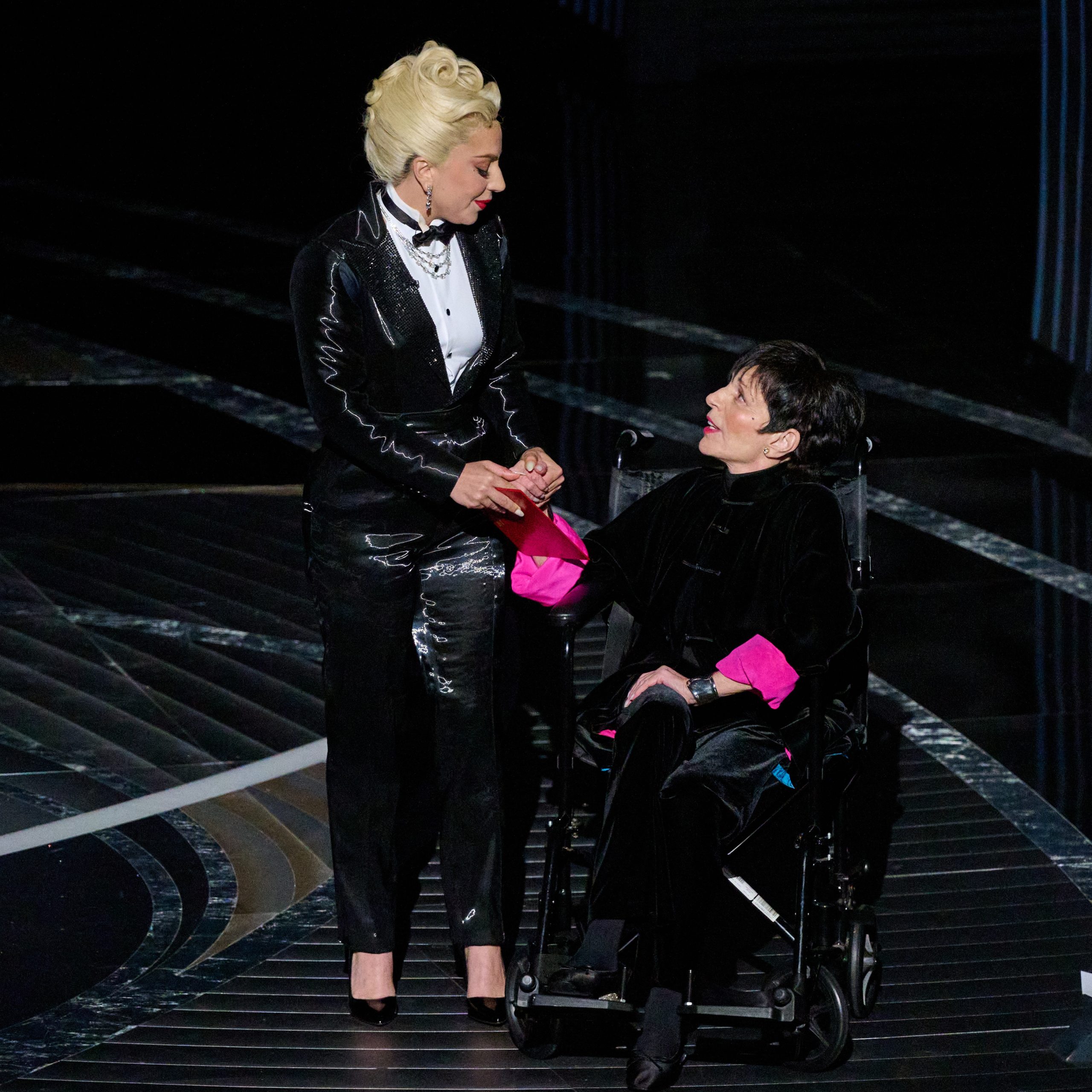 Lady Gaga’s black Jimmy Choo Romy pumps peek out beneath her Ralph Lauren tuxedo jumpsuit as she presents Best Picture with Liza Minnelli at the Oscars