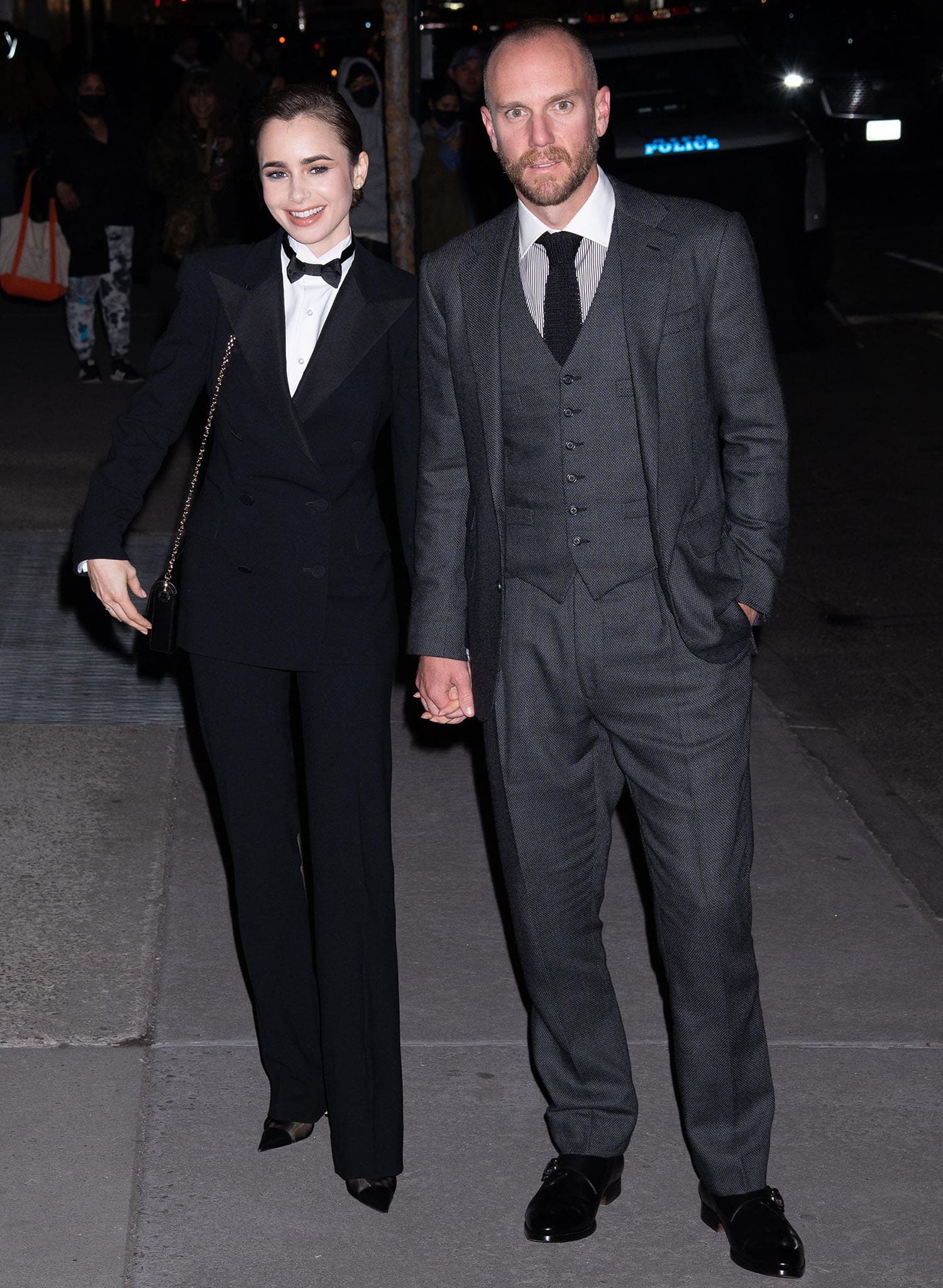 Lily Collins' husband Charlie McDowell looks dapper in a three-piece gray suit with a striped shirt and a black tie