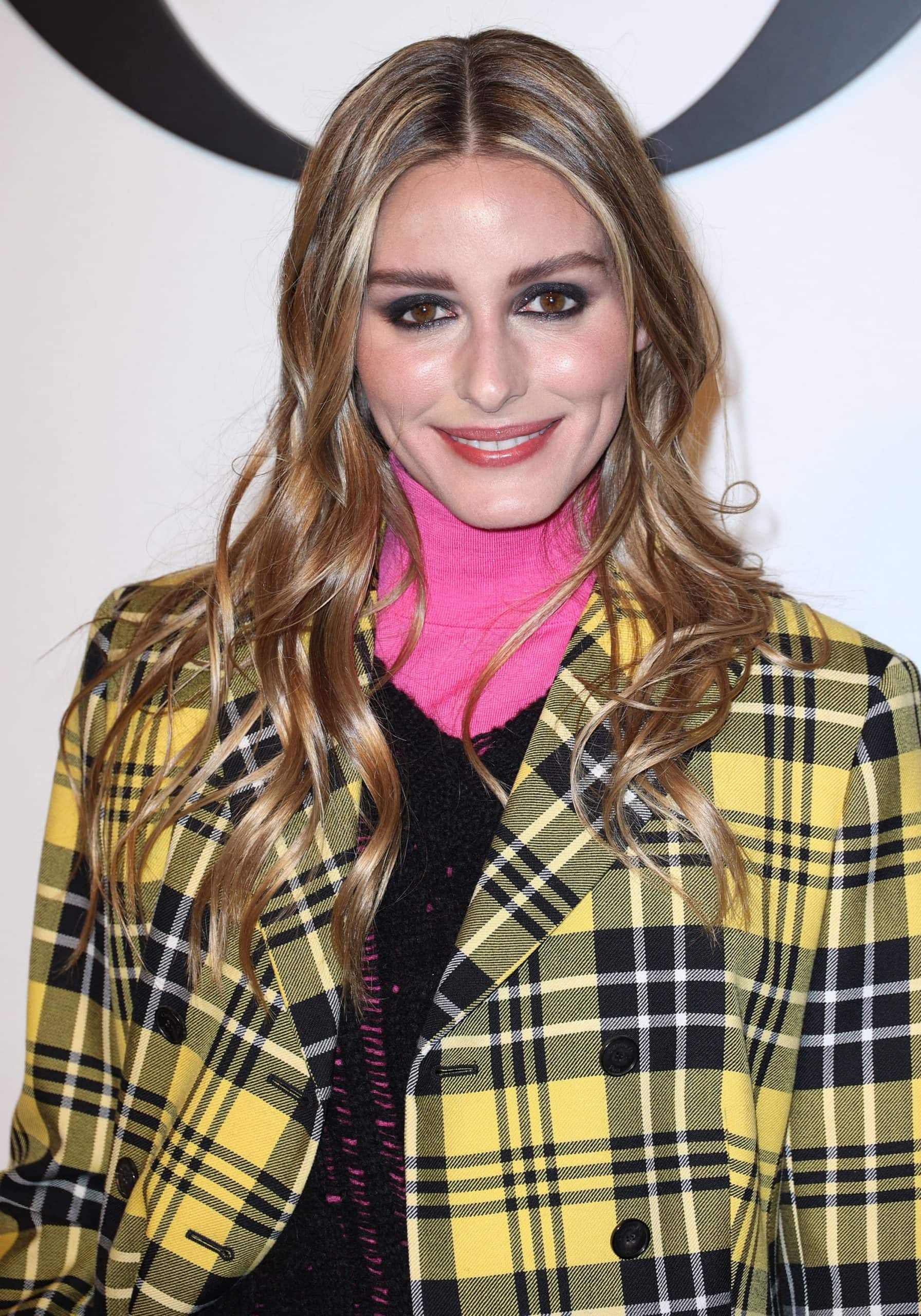 Olivia Palermo wears smokey eyeshadow and styles her tresses down in waves