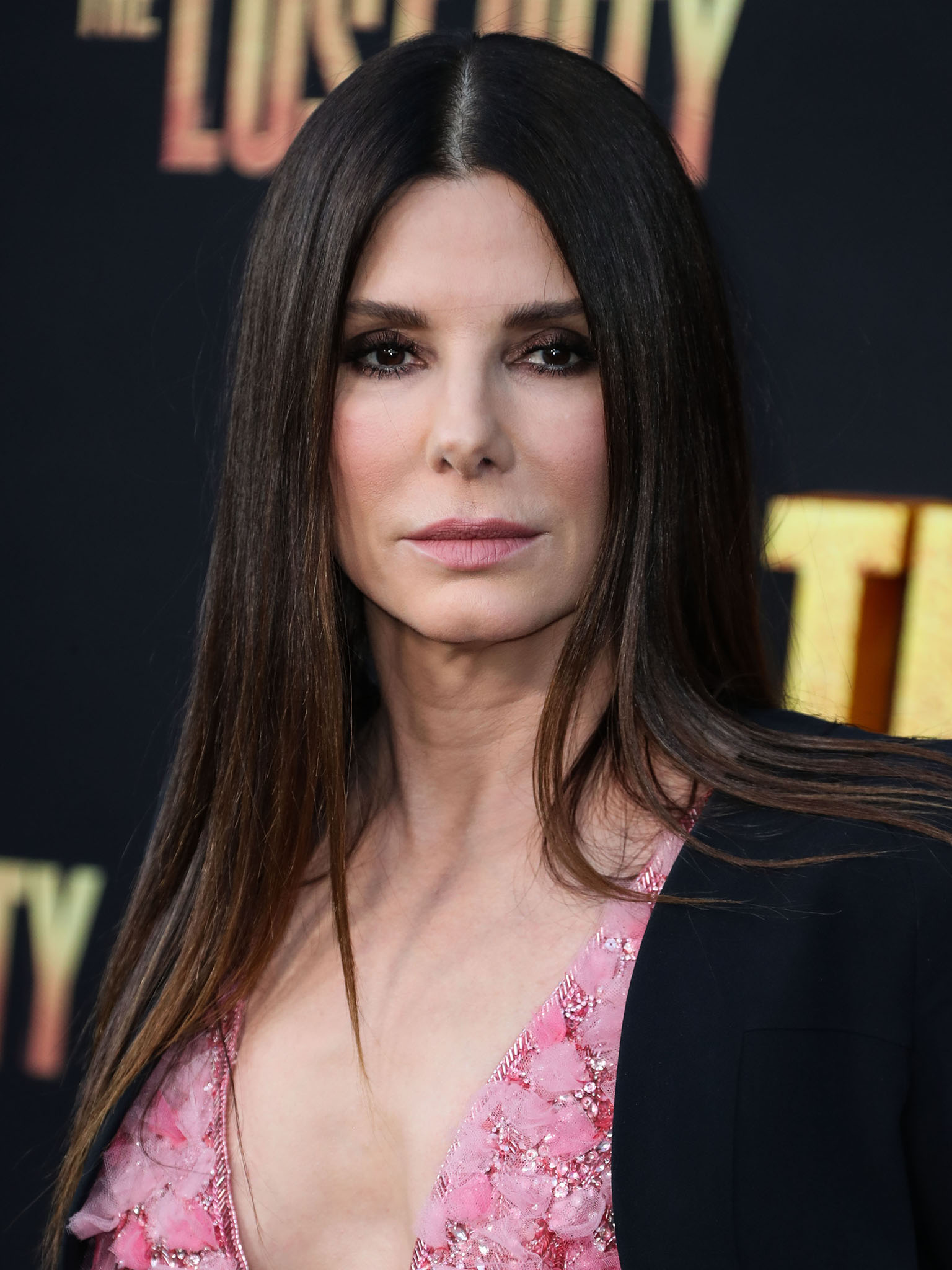 Sandra Bullock flashes her cleavage and wears sultry smokey eyeshadow and straightened locks