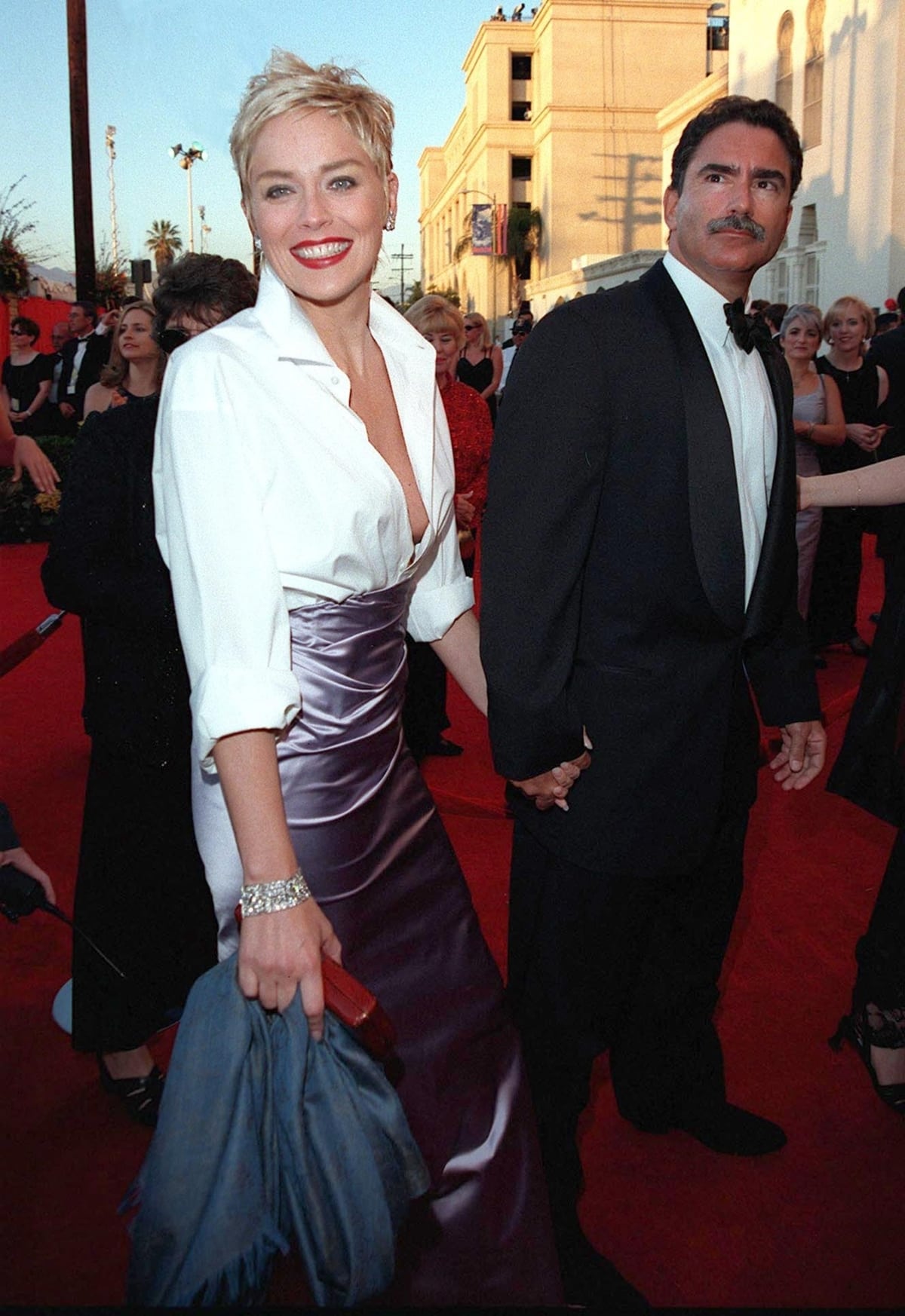 Sharon Stone in a Gap shirt and a Vera Wang skirt with her then-husband Phil Bronstein during the 70th Academy Awards ceremony
