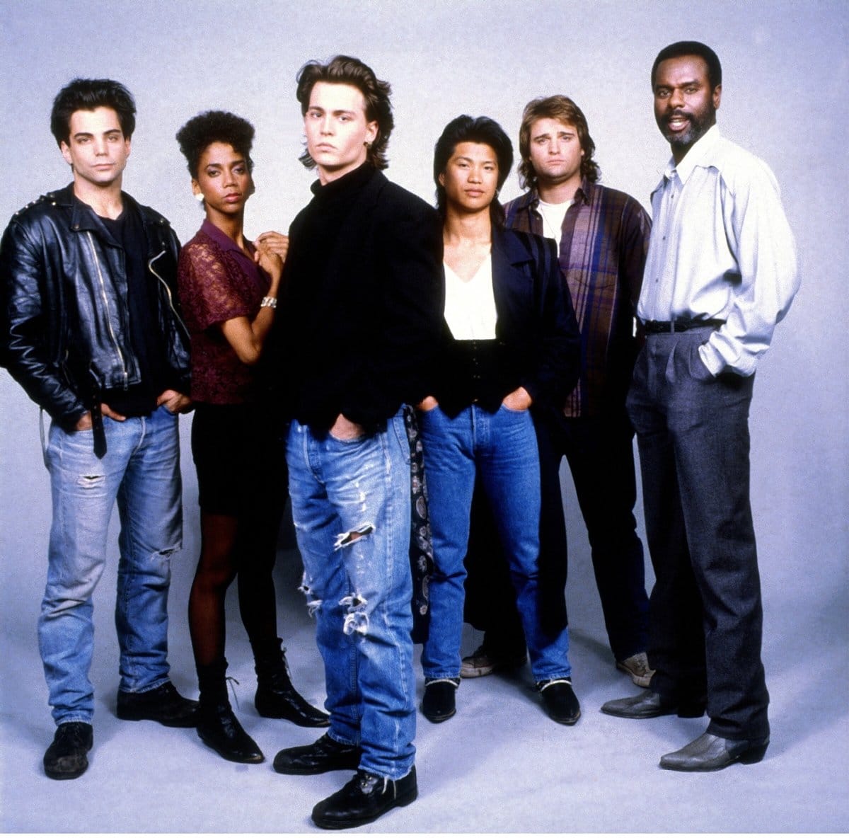 Johnny Depp as Officer Tom Hanson, Steven Williams as Captain Adam Fuller, Peter DeLuise as Officer Doug Penhall, Dustin Nguyen as Officer Harry Truman Ioki, Holly Robinson Peete as Officer Judy Hoffs, and Richard Grieco as Detective Dennis Booker in the American police procedural television series 21 Jump Street