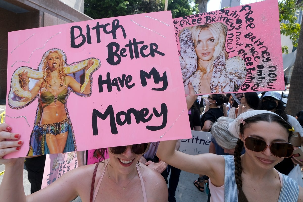 Supporters of Britney Spears hold a placard saying "Bitch Better Have My Money" outside the Stanley Mosk Courthouse