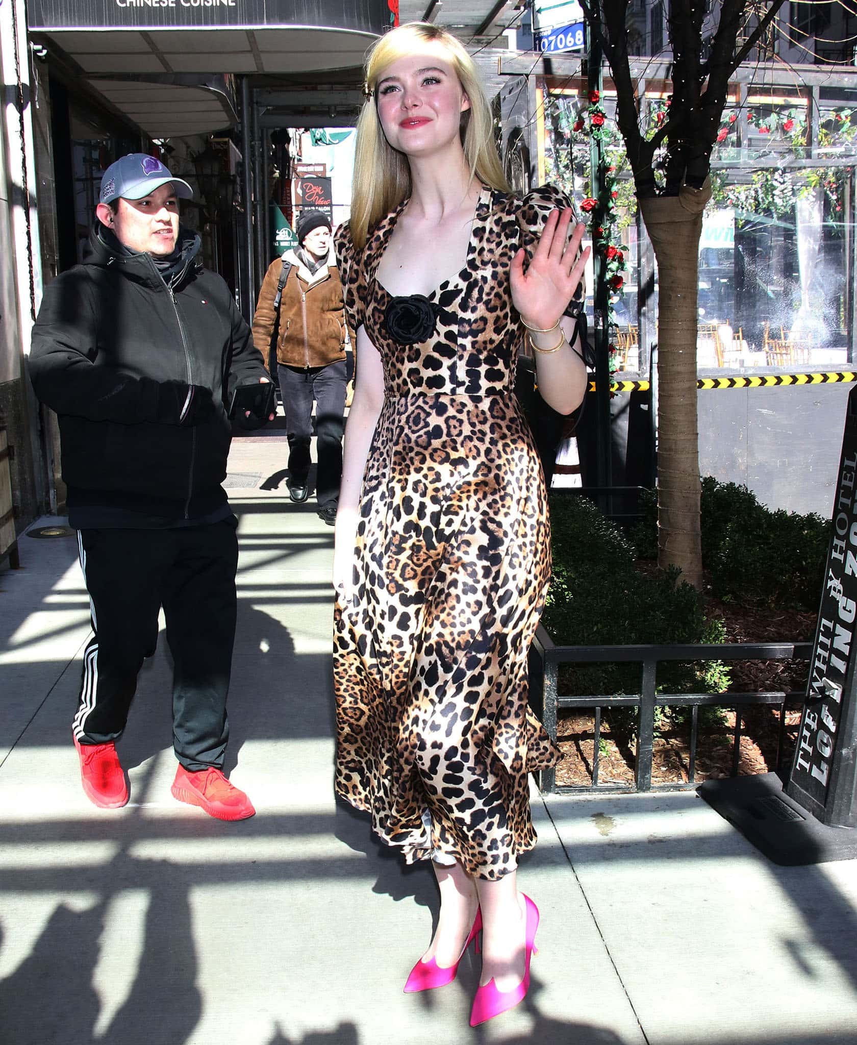 Elle Fanning makes a striking appearance on Live with Kelly and Ryan in a leopard-print Rodarte midi dress on March 29, 2022