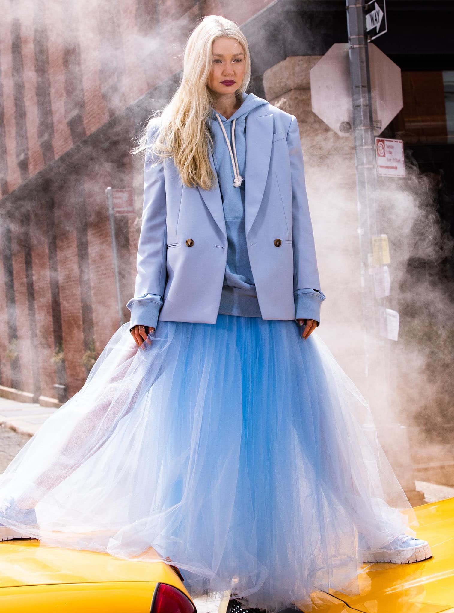 Gigi Hadid channels Carrie Bradshaw in a voluminous blue tulle skirt, a blue hoodie, and a blazer