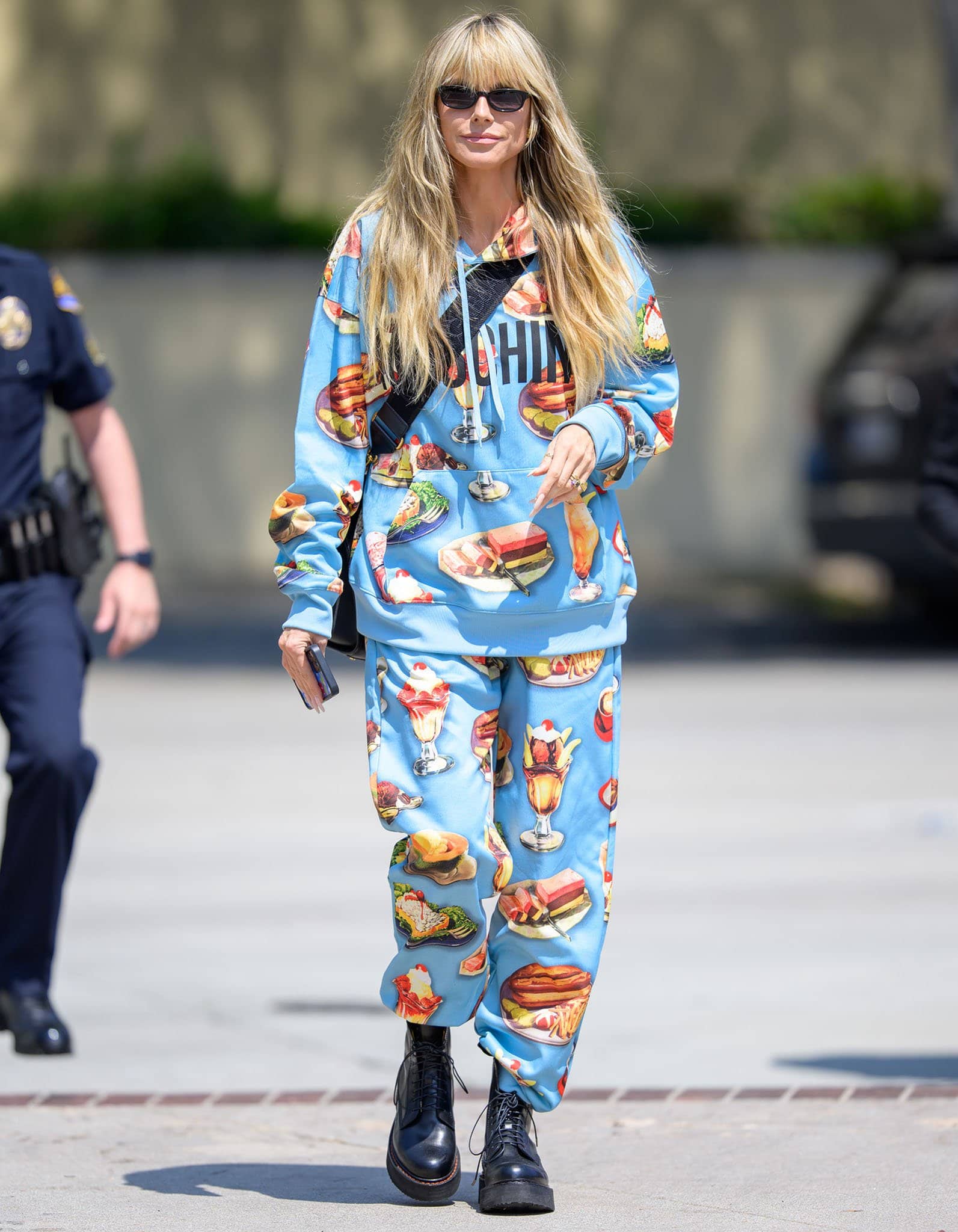 Heidi Klum wears a Moschino baby blue tracksuit designed with diner food prints all over