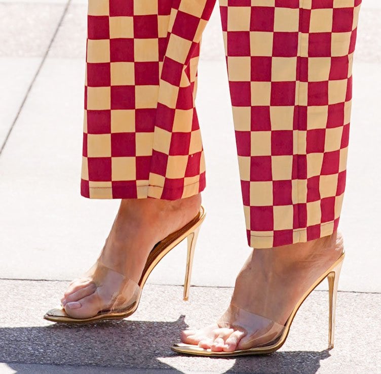 Heidi Klum slips her big feet into Gianvito Rossi's Elle clear PVC and gold mules