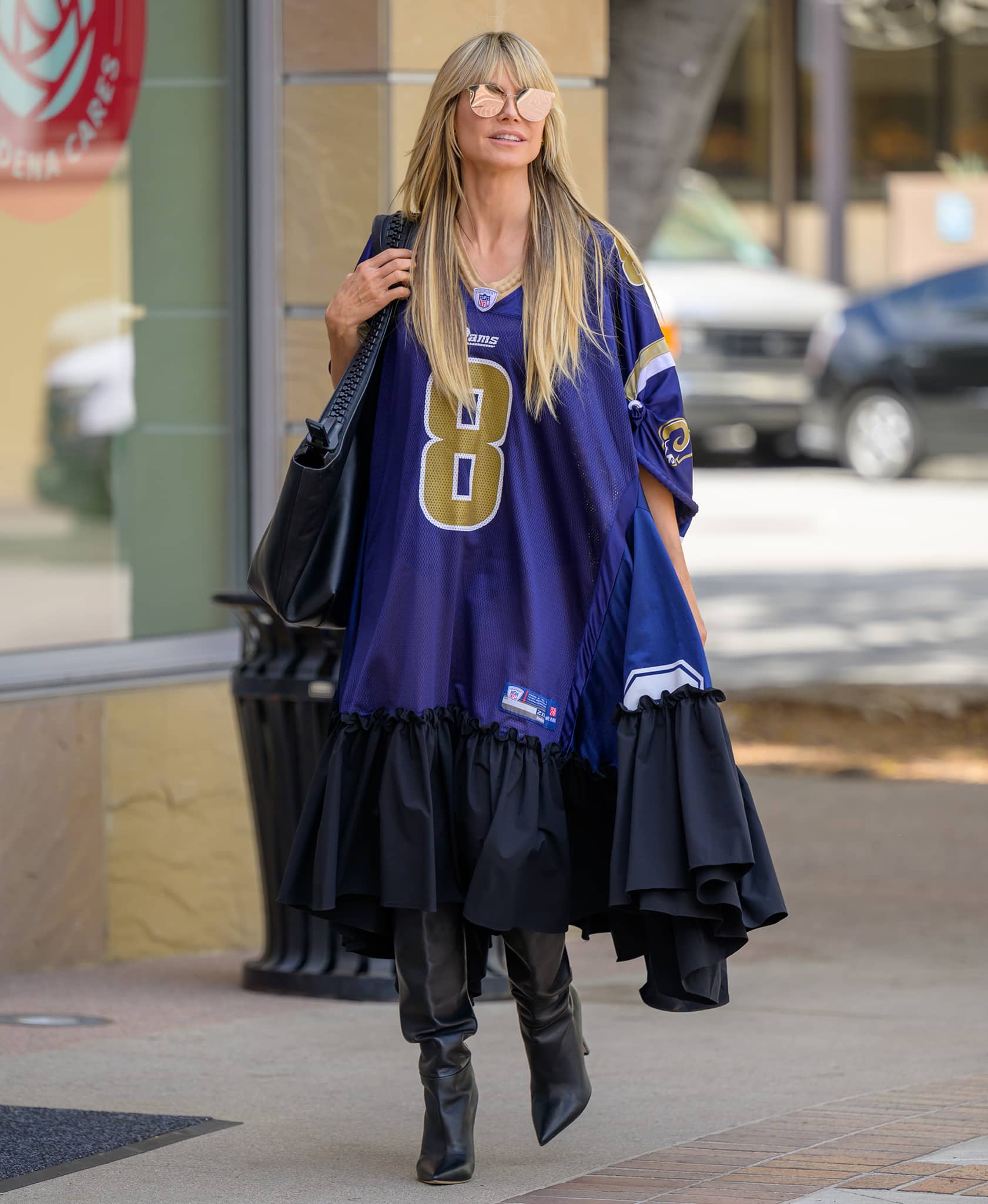 Heidi Klum shows support for Los Angeles Rams in an oversized football jersey dress with Saint Laurent Kiki thigh-high boots