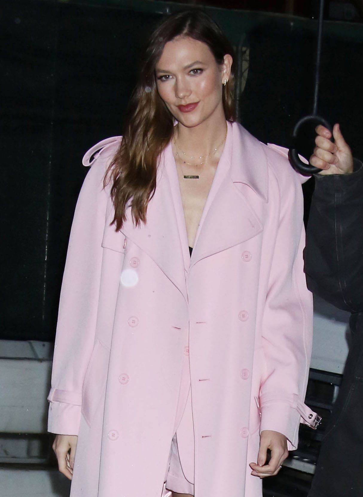 Karlie Kloss keeps the monochromatic pink look going with pink lip color and highlights her eyes with mascara and eyeliner