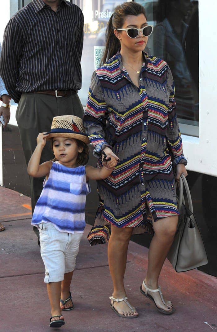 Kourtney Kardashian styled a Mara Hoffman stepped hem dress with Fendi jelly flat thong sandals