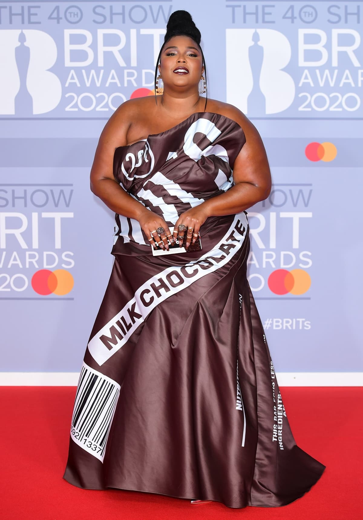 Lizzo wears a Jeremy Scott for Moschino dress inspired by the American chocolate brand Hershey’s for The BRIT Awards 2020