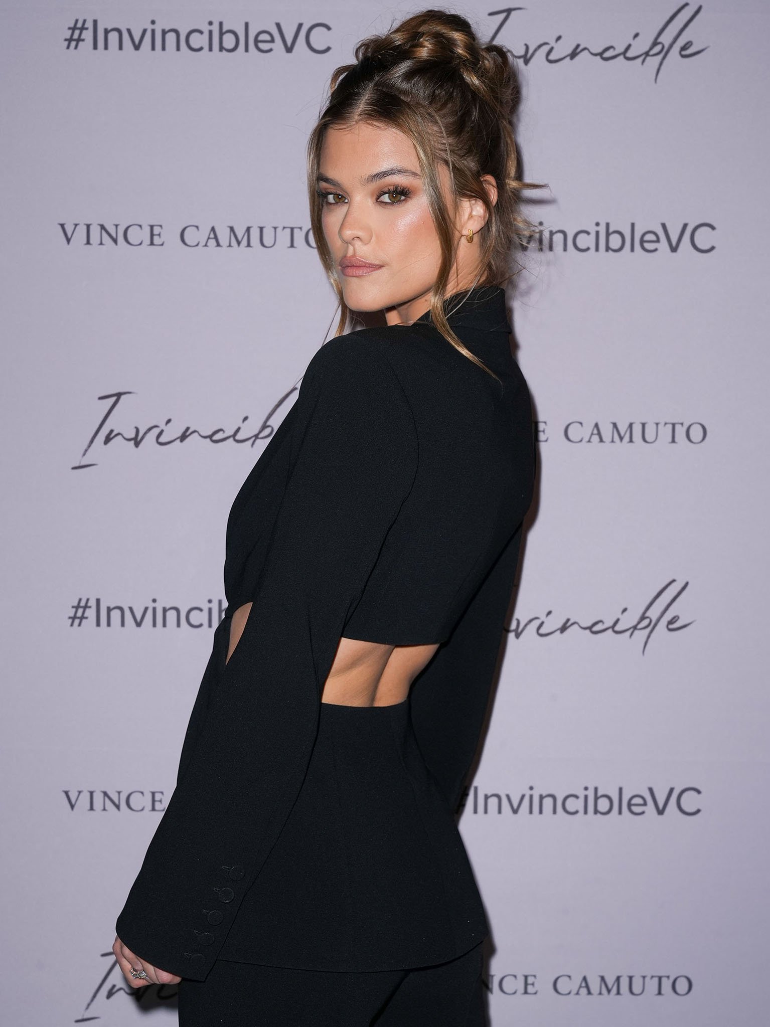 Nina Agdal styles her tresses in a braided updo and wears smokey eyeshadow and matte nude pink lipstick