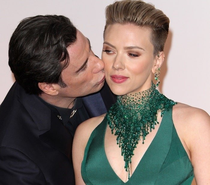 An unexpected moment: John Travolta shares a congenial kiss on the cheek with Scarlett Johansson, capturing attention