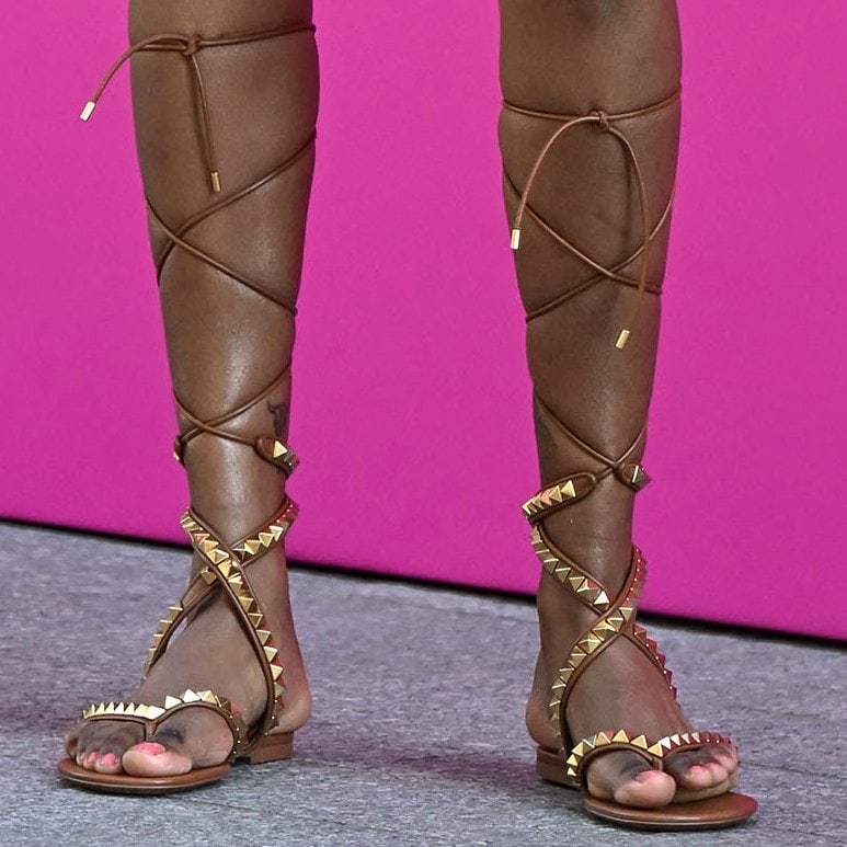 Simone Ashley shows off her feet in studded lace-up gladiator sandals