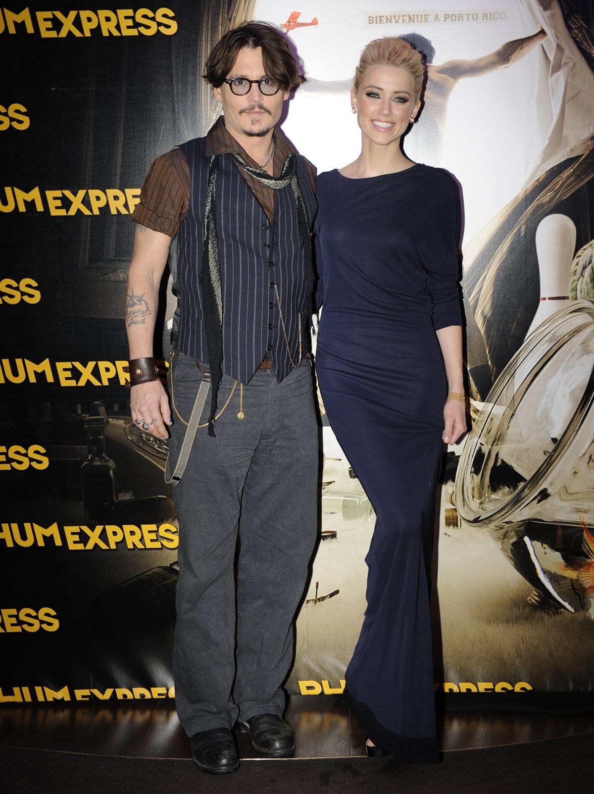 Johnny Depp and Amber Heard in a Stella McCartney dress styled with Boucheron jewelry attend the premiere of The Rum Diary