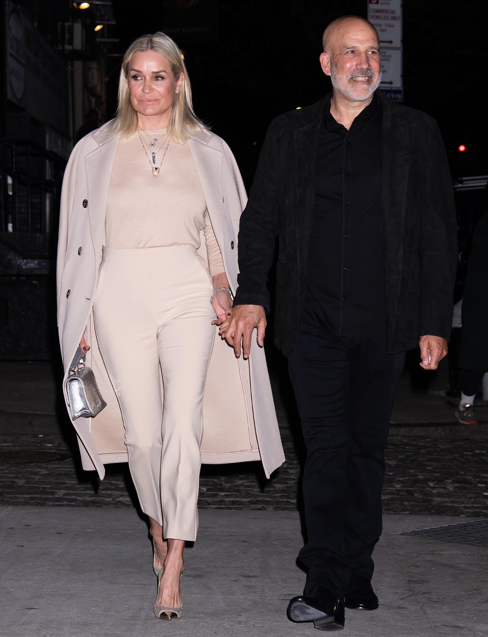 Yolanda Hadid glams up in monochromatic nude outfit as she holds hands with boyfriend Joseph Jingoli on her way to the venue