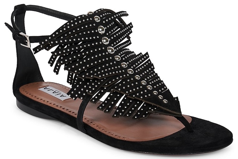 These Alaia flat sandals feature studded fringes along the t-strap