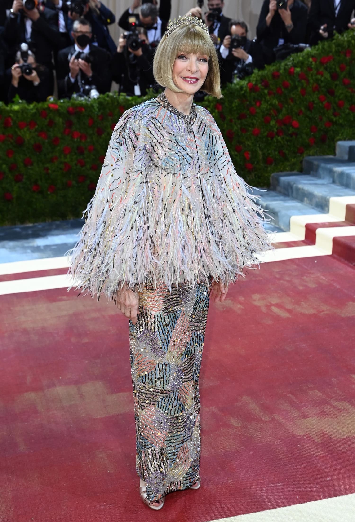 Anna Wintour wears a tiara with a beaded pink feathered Chanel gown at the 2022 Met Gala Celebrating "In America: An Anthology of Fashion" at The Metropolitan Museum of Art