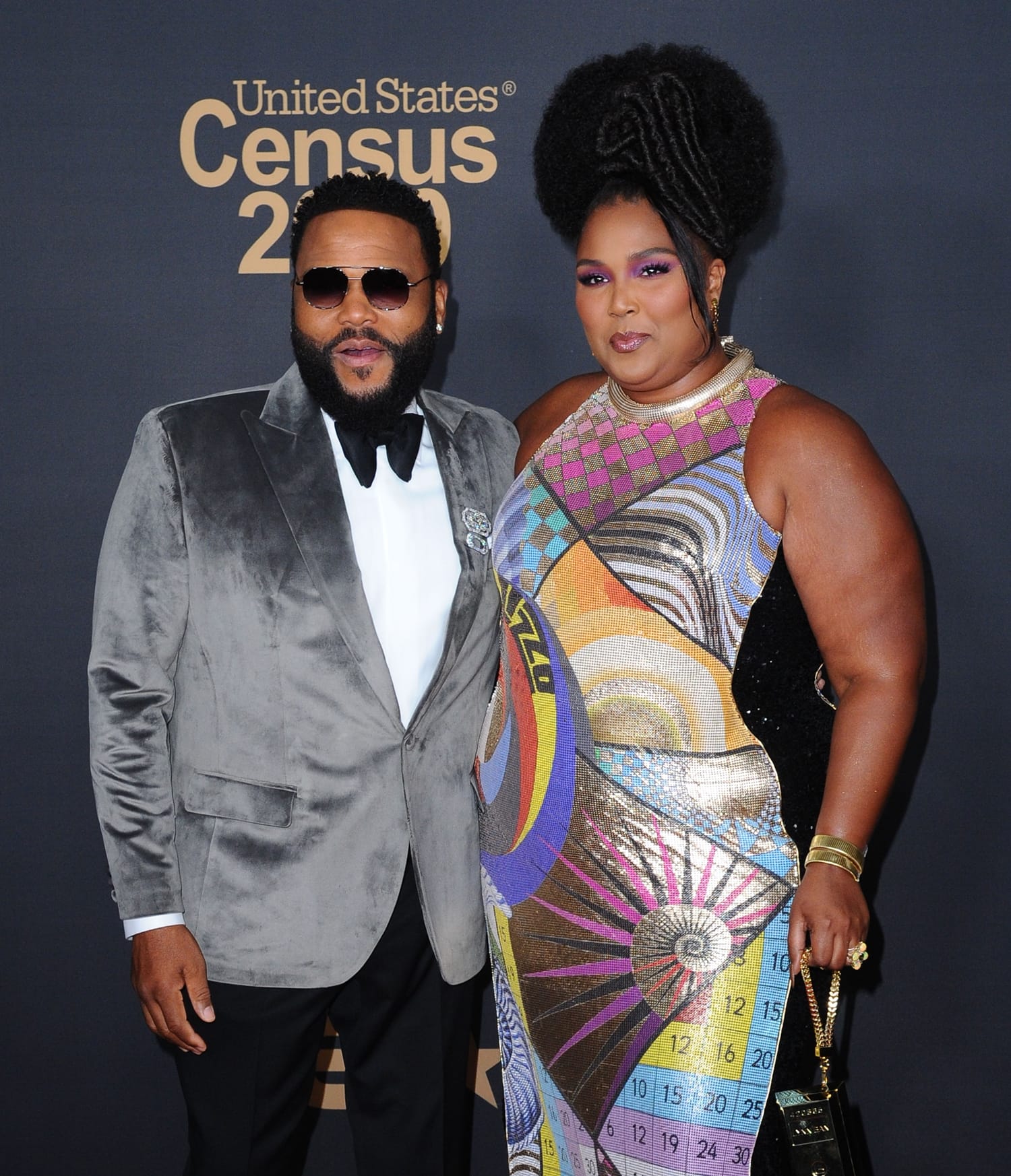 Lizzo, in a custom Mary Katrantzou geometric dress, posing with Anthony Anderson at the 51st NAACP Image Awards