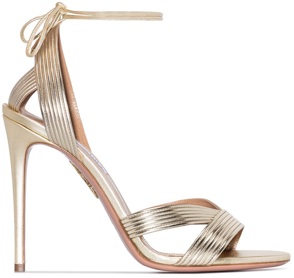 The Aquazzura Ari sandals feature a pale gold upper with tie-fastenings and thin heels