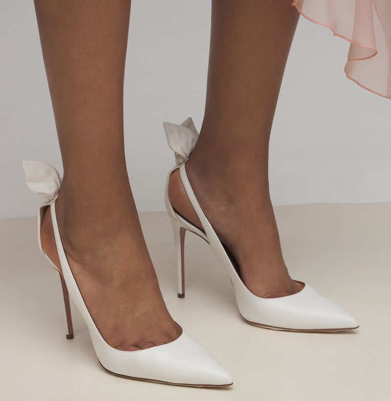 The back bow-tie detail adds a feminine touch to the classic pointed-toe pumps silhouette