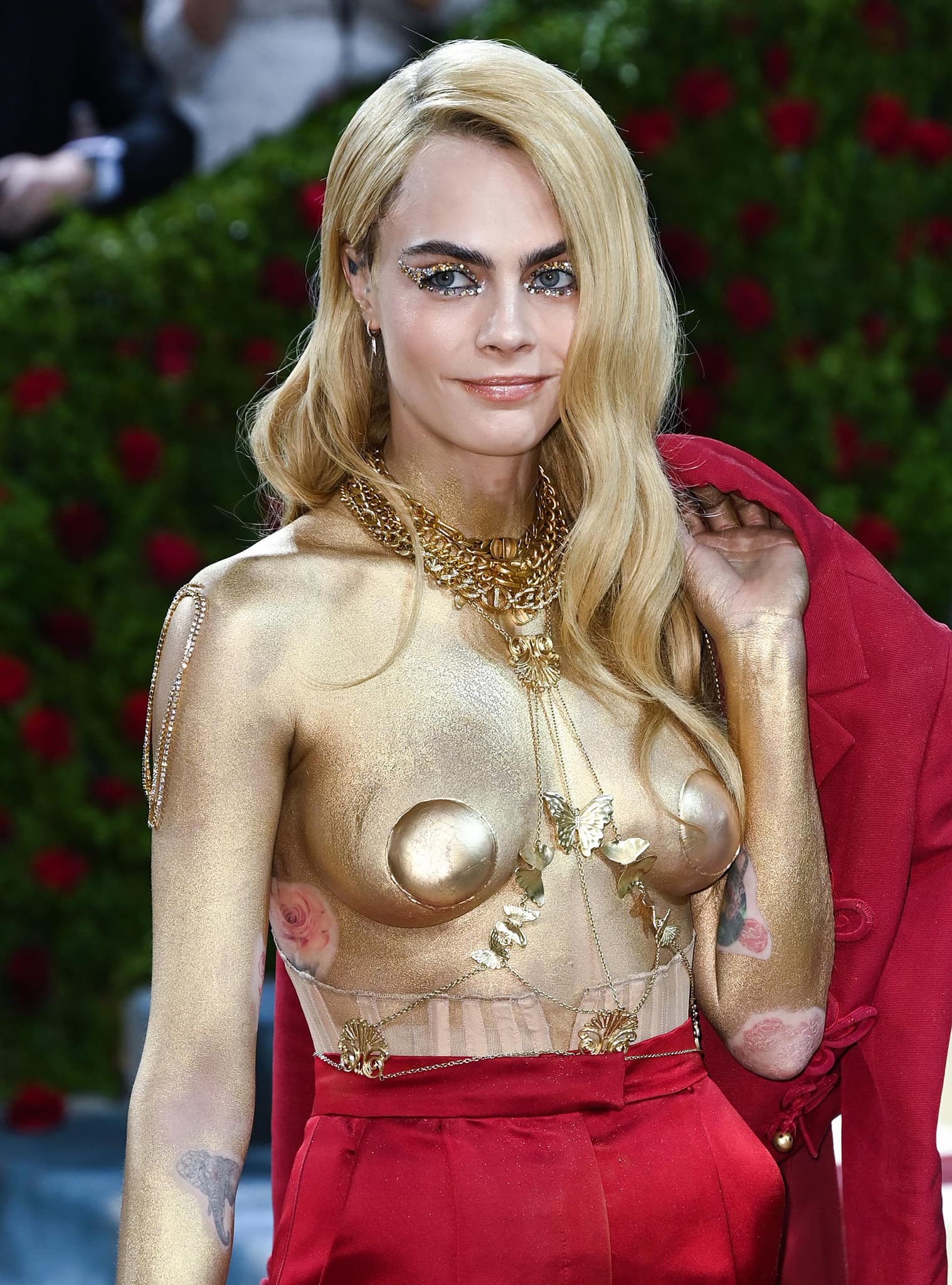 Cara Delevingne's eyes are lined with gold crystals, completing her take on gilded age look