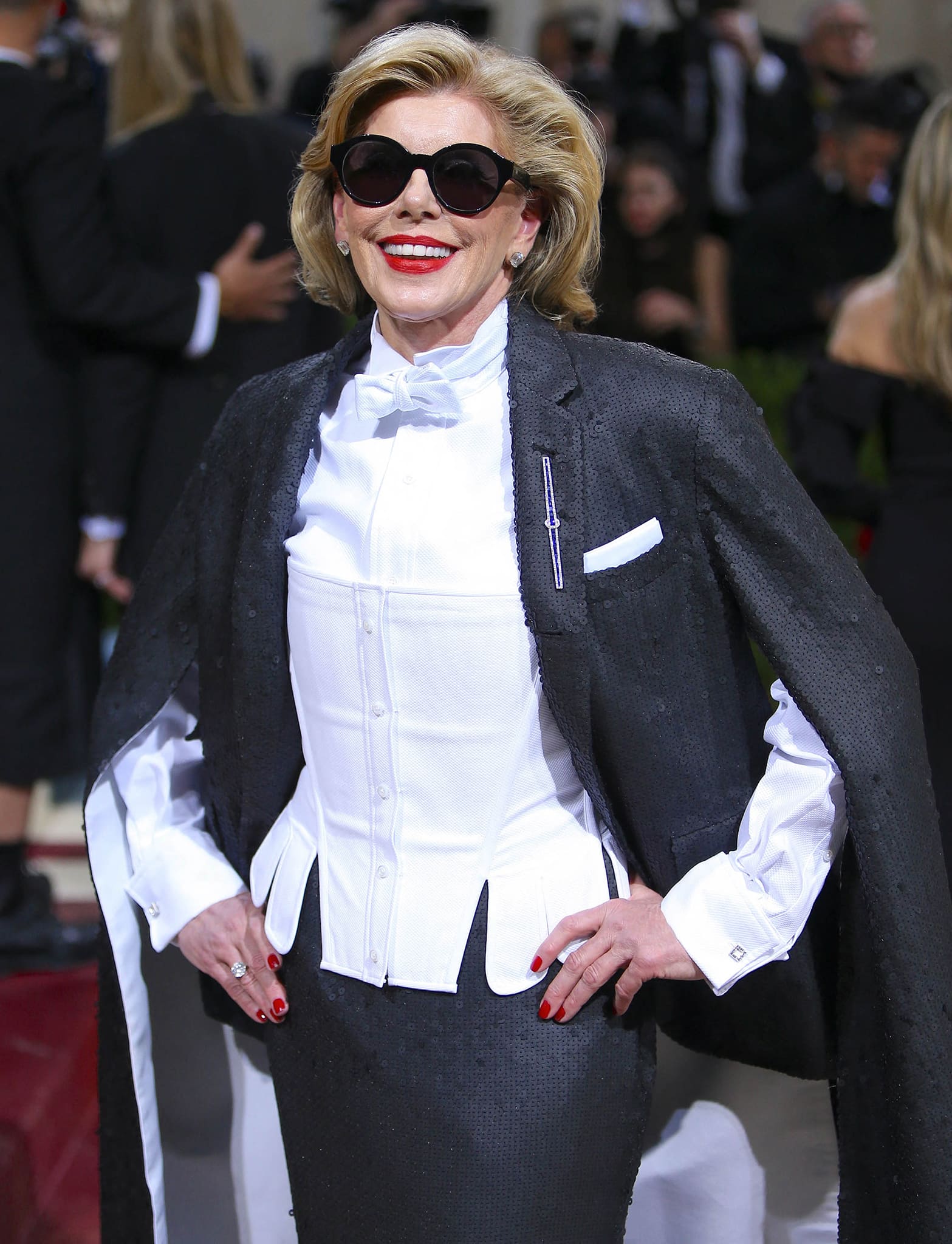 Christine Baranski adds a feminine twist to her look with Kwiat diamonds, red lipstick, and matching nail polish