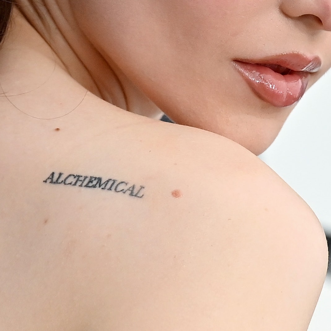 Dove Cameron had "ALCHEMICAL" inked on her upper left shoulder in January 2021