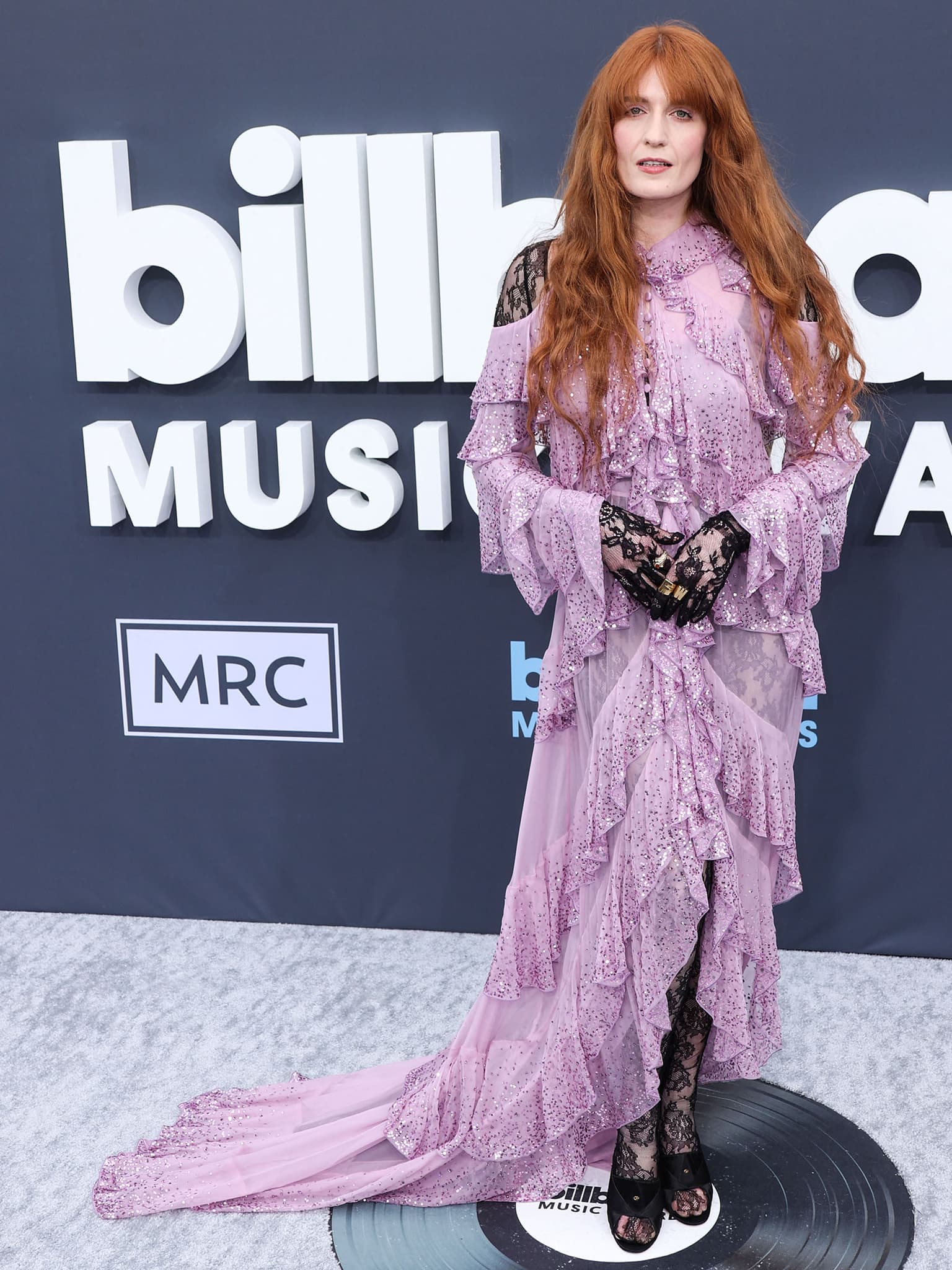 Florence Welch wears a purple sequin-embellished Gucci tiered dress with a black lace catsuit