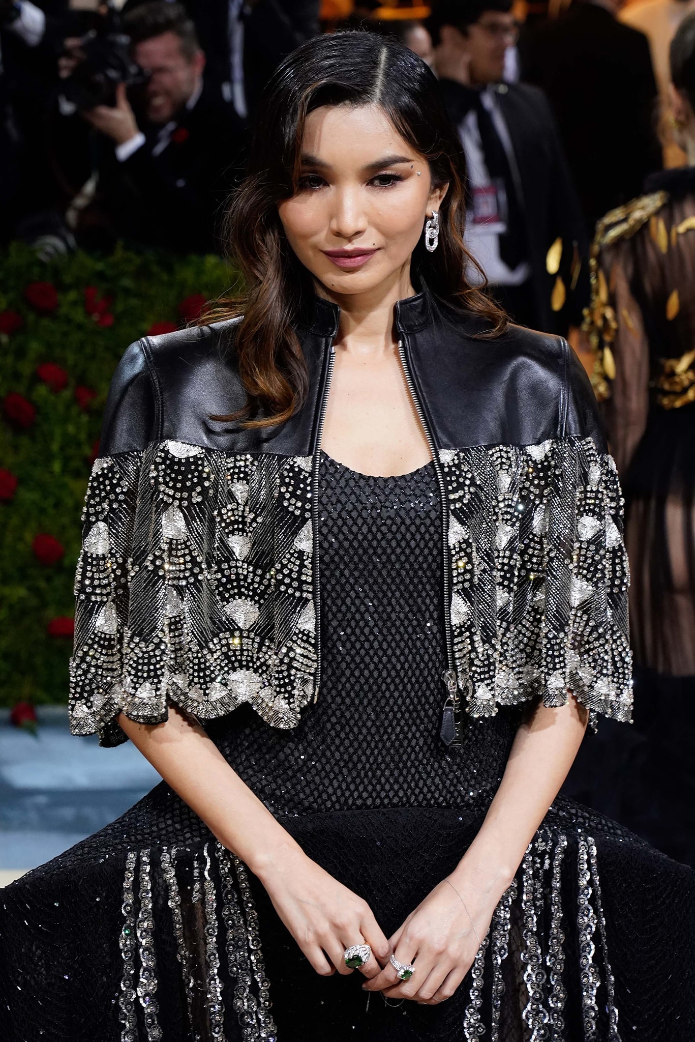 Gemma Chan wears retro soft waves and chrome nail polish with a delicate silver chain nail bracelet