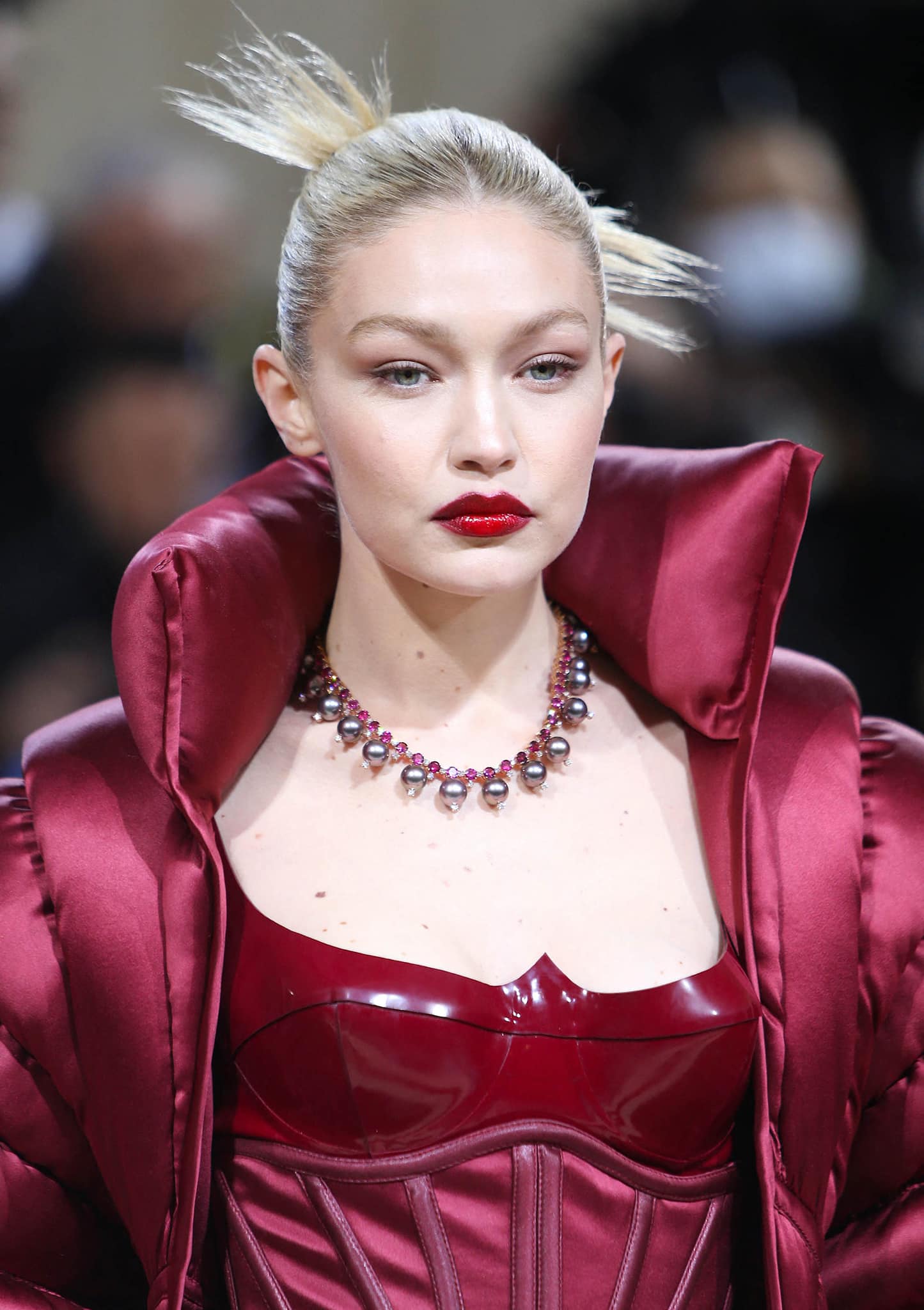Gigi Hadid finishes off a vampy look with a spiky updo and a swipe of red lipstick
