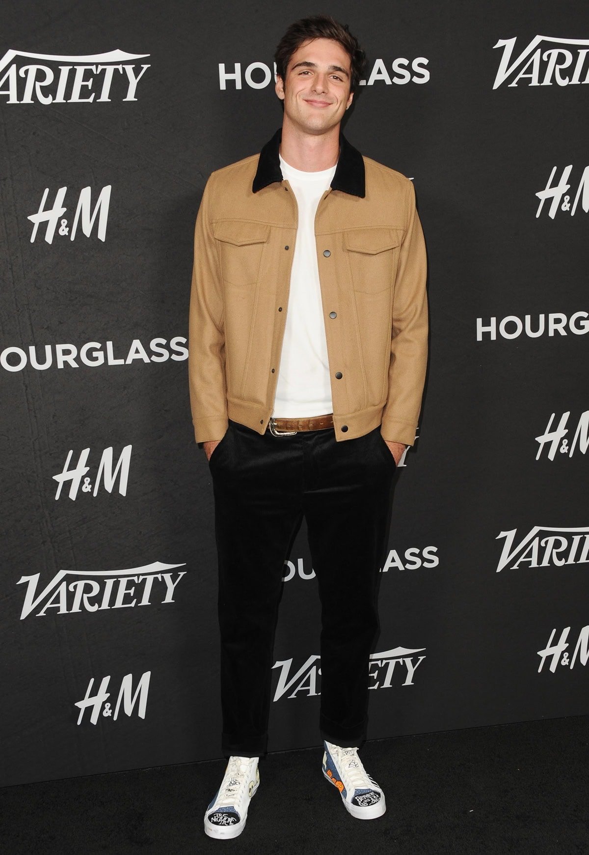 Jacob Elordi kept it effortlessly cool at Variety’s Power of Young Hollywood event in a camel-colored Fear of God jacket over a crisp white tee and slim black trousers, finishing the look with standout paint-splattered Dior B23 high-top sneakers