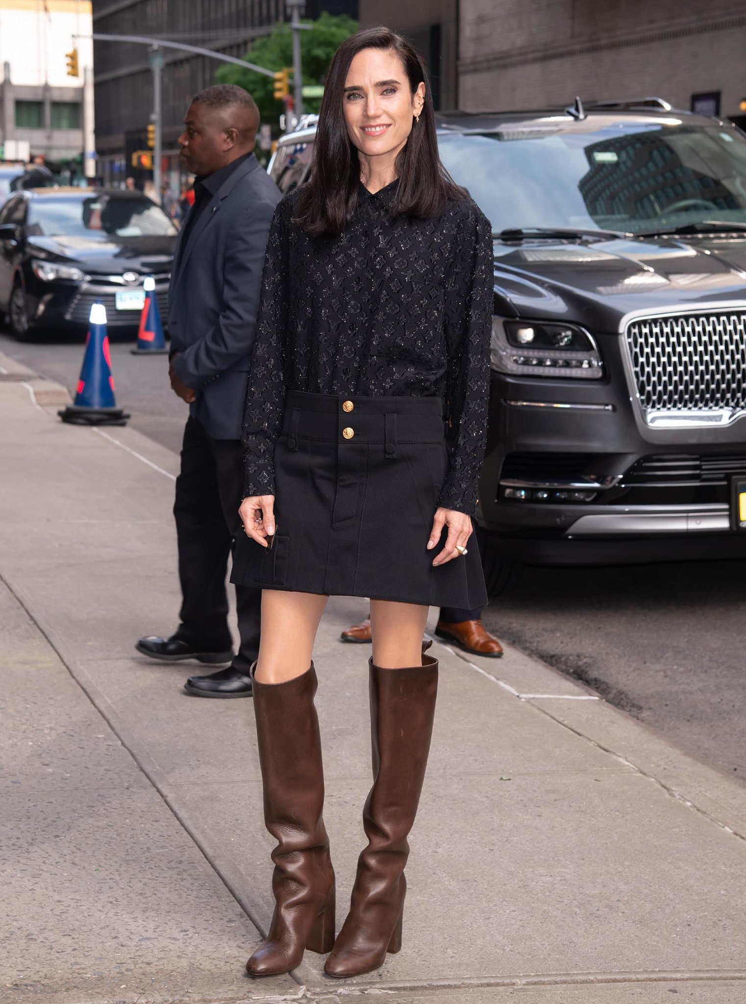 Jennifer Connelly outside the Late Show with Stephen Colbert studios in a Louis Vuitton blouse, mini skirt, and brown knee-high boots