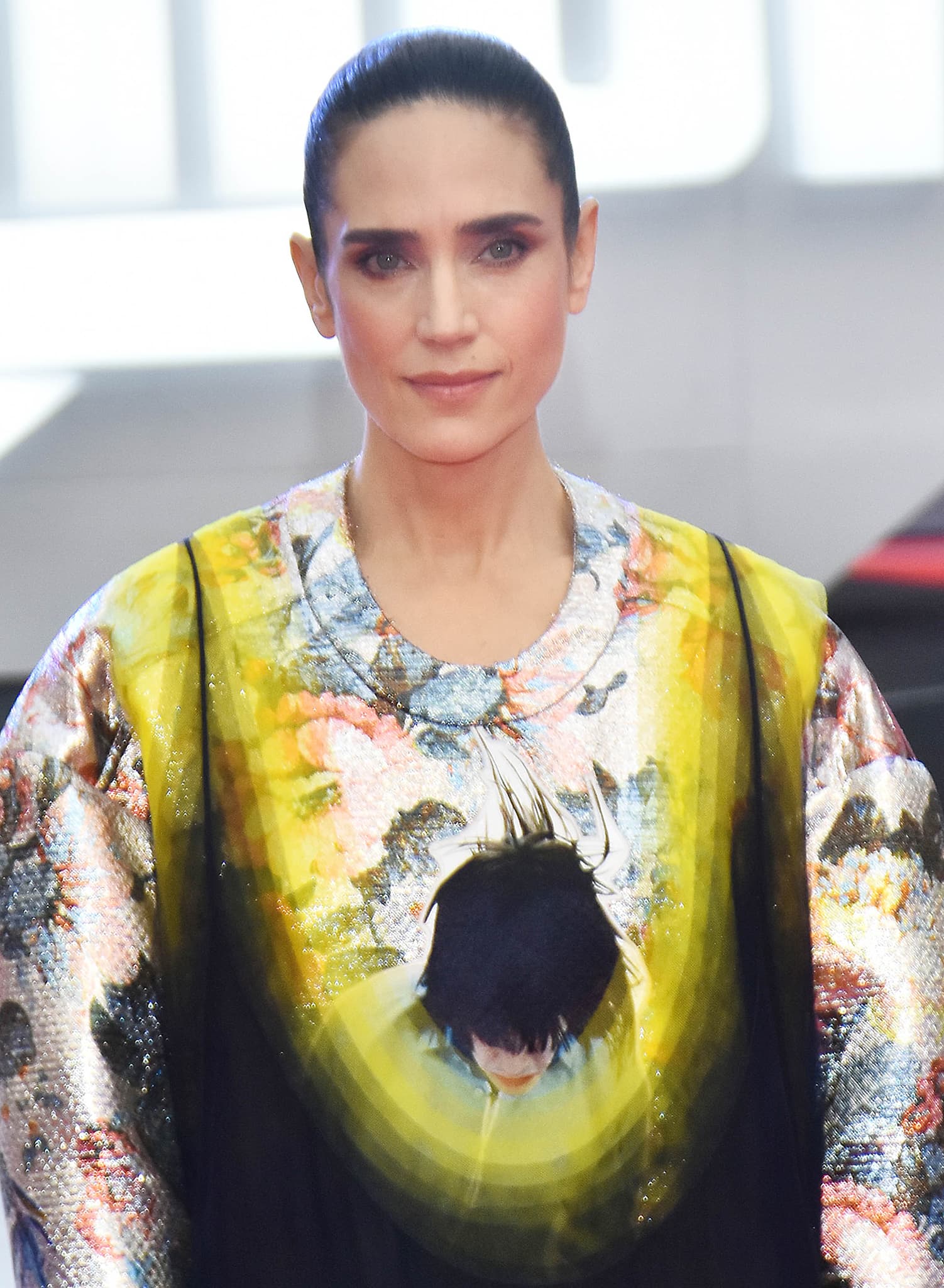 Jennifer Connelly styles her dark hair in a sleek bun and sports smokey eyeshadow and nude pink lipstick