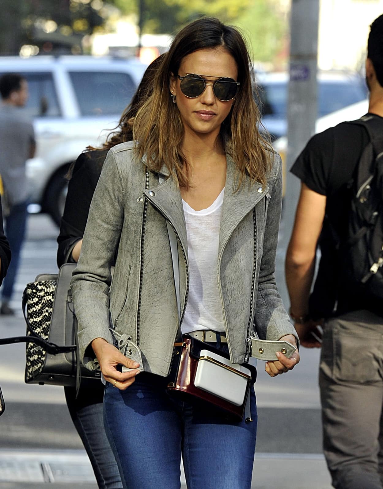 Jessica Alba wears a grey IRO Jova leather jacket with jeans, a Mary Katrantzou shoulder bag, and Ill.I by Will.I.Am Wa508s 04 sunglasses