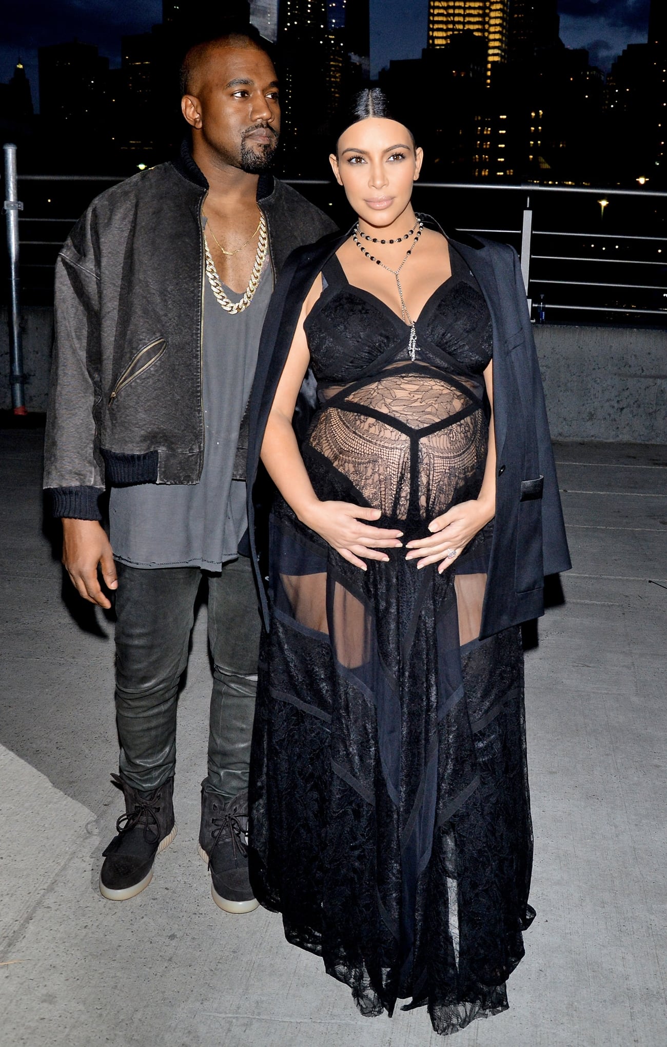 Kim Kardashian shows up her pregnant belly in a sheer dress with Kanye West at the Givenchy fashion show