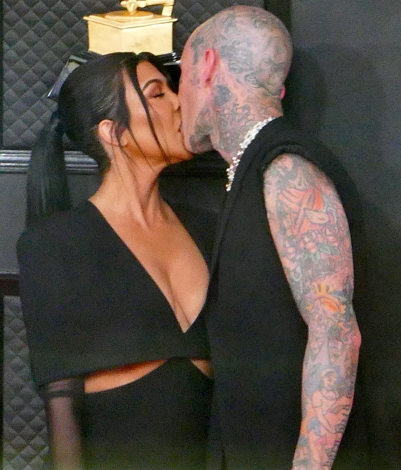 Kourtney Kardashian and Travis Barker kiss at the 64th Annual GRAMMY Awards