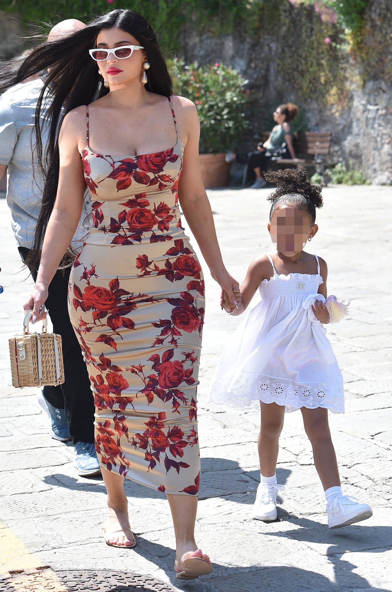 Kylie Jenner wows in a figure-hugging D&G '90s floral dress as she holds hands with daughter Stormi