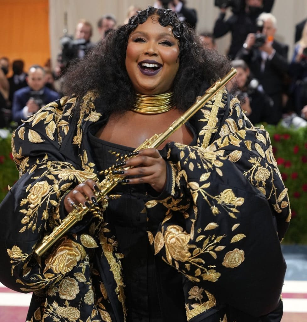 Lizzo Plays Gold John Lunn Flute on Met Red Carpet