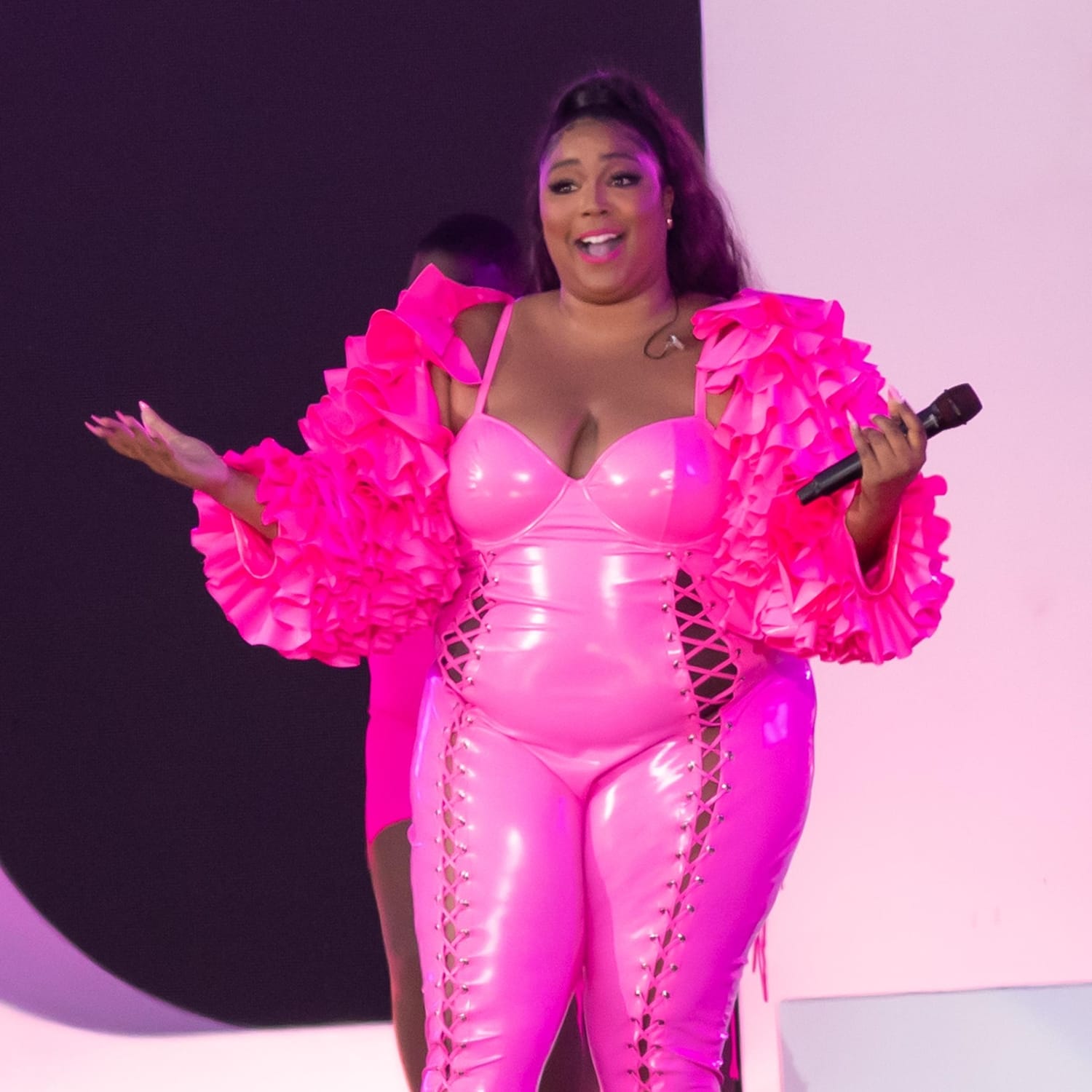 Lizzo performs in a hot pink catsuit with lace-up cutouts at 2021 Global Citizen Live: New York