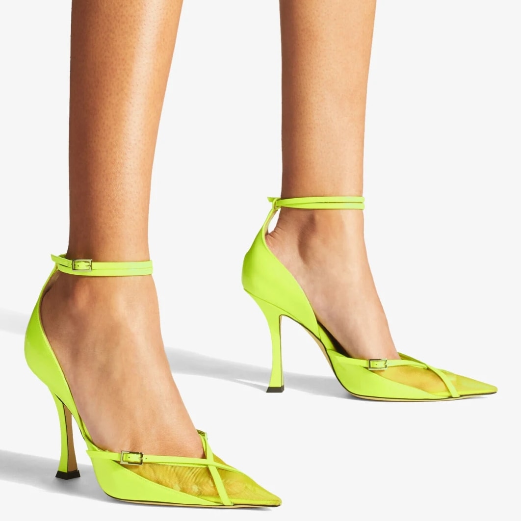The pointed-toe pump features a sharp silhouette and is crafted in Italy from a combination of bright neon yellow patent and mesh