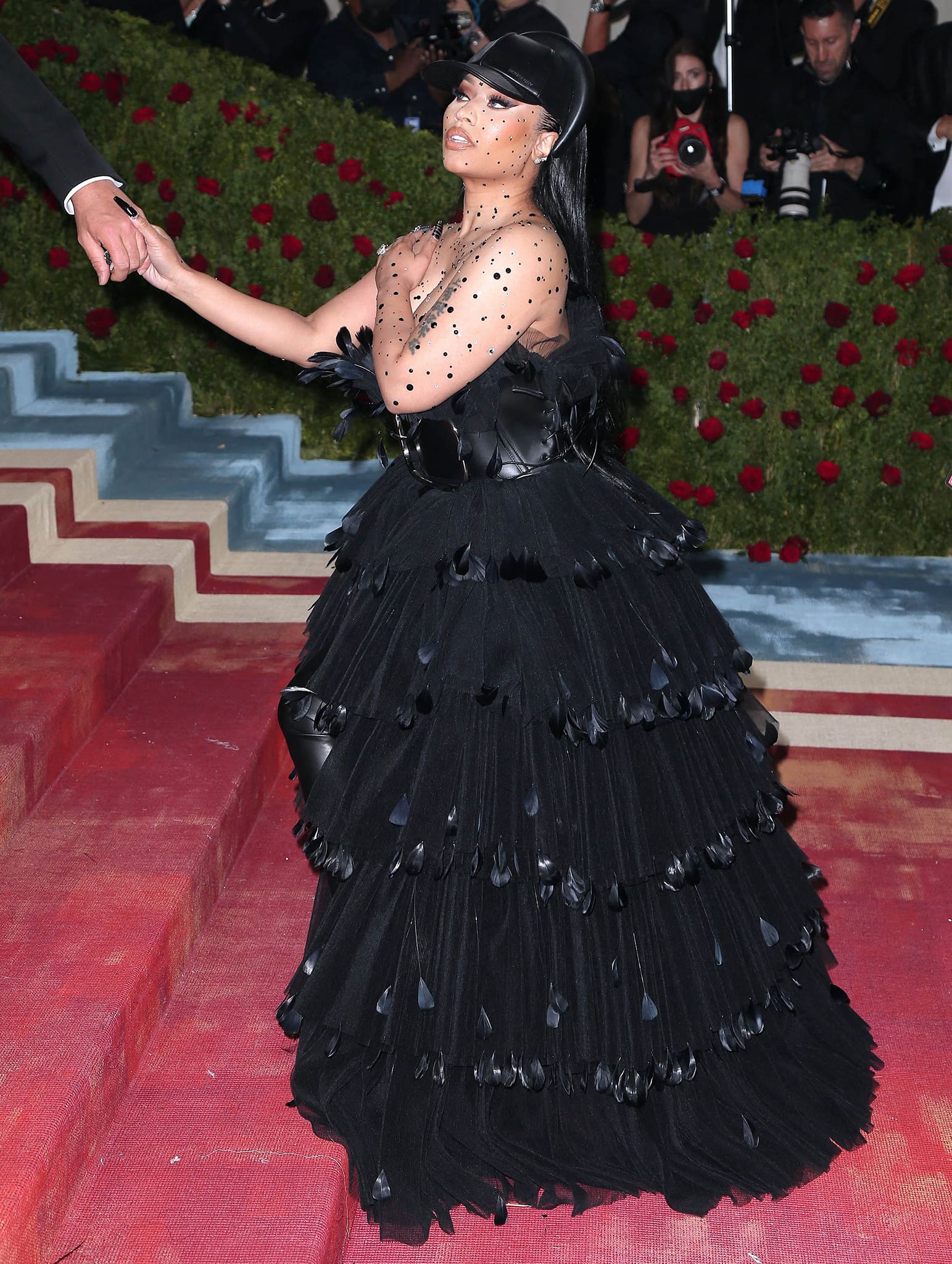 Nicki Minaj narrowly avoids a wardrobe malfunction as Burberry made the cup size of her outfit a little small