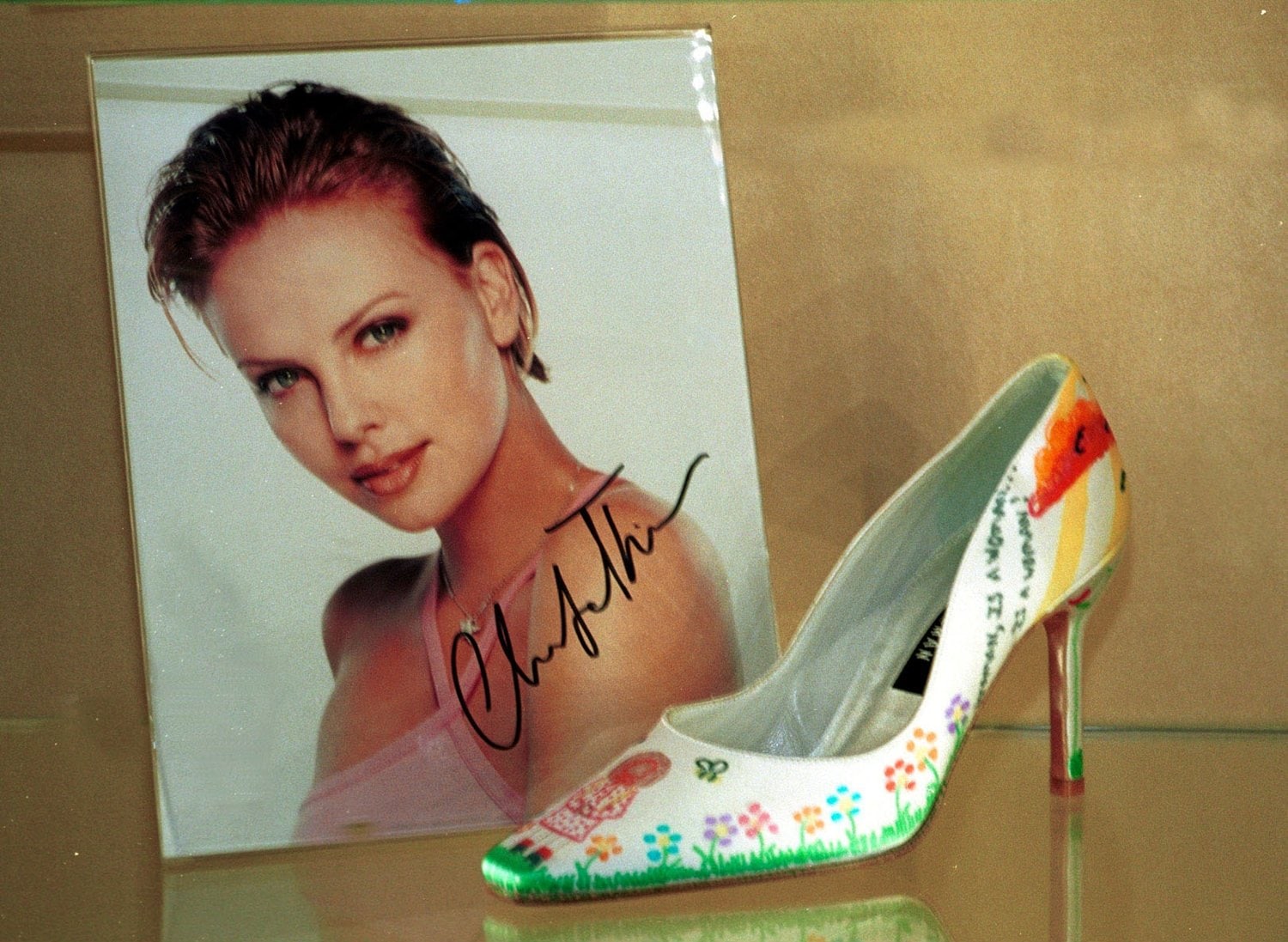 A Stuart Weitzman shoe decorated by Charlize Theron for charity
