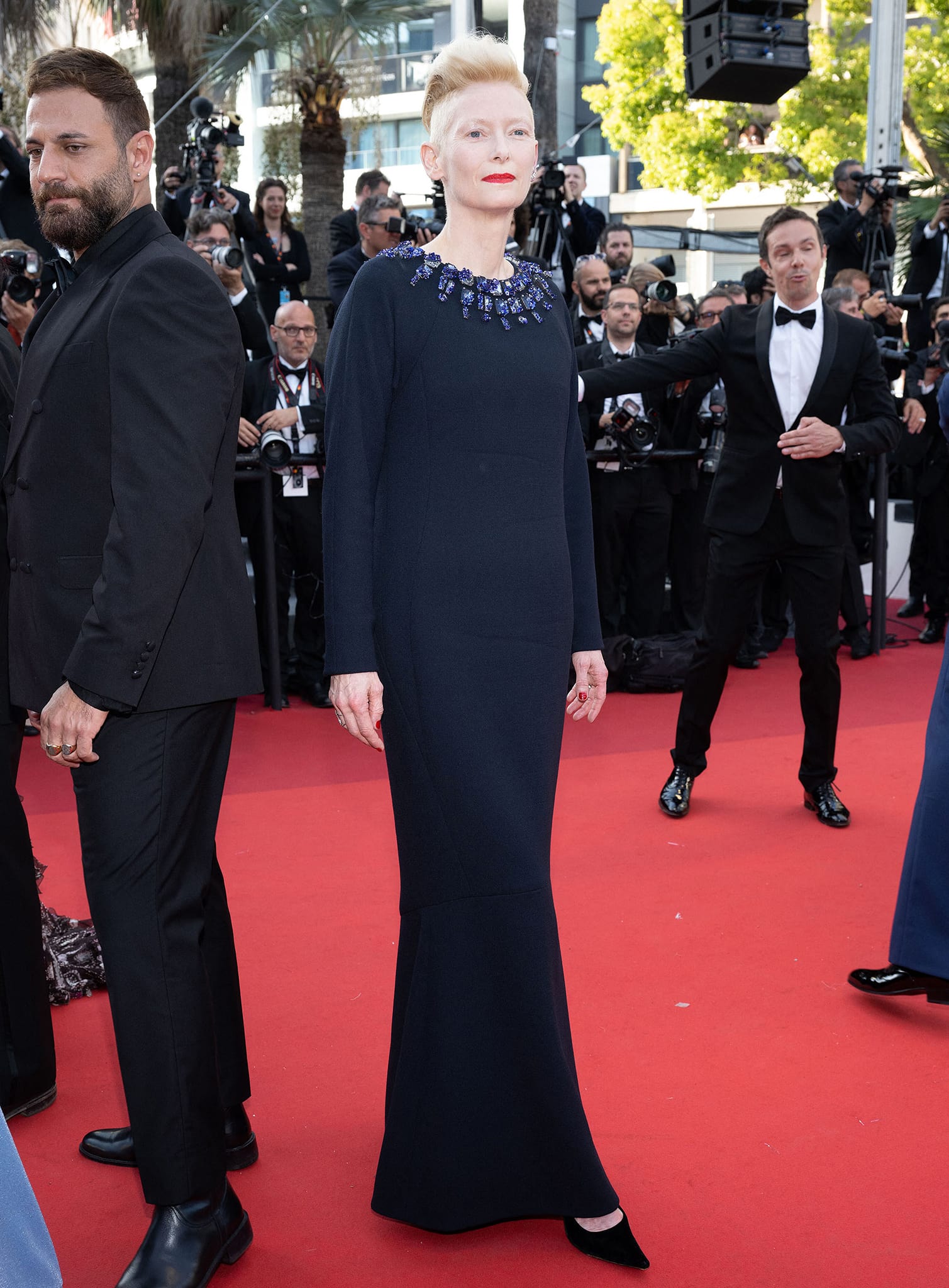 Tilda Swinton looks elegant in a navy blue Chanel dress with a crystal-embellished neckline