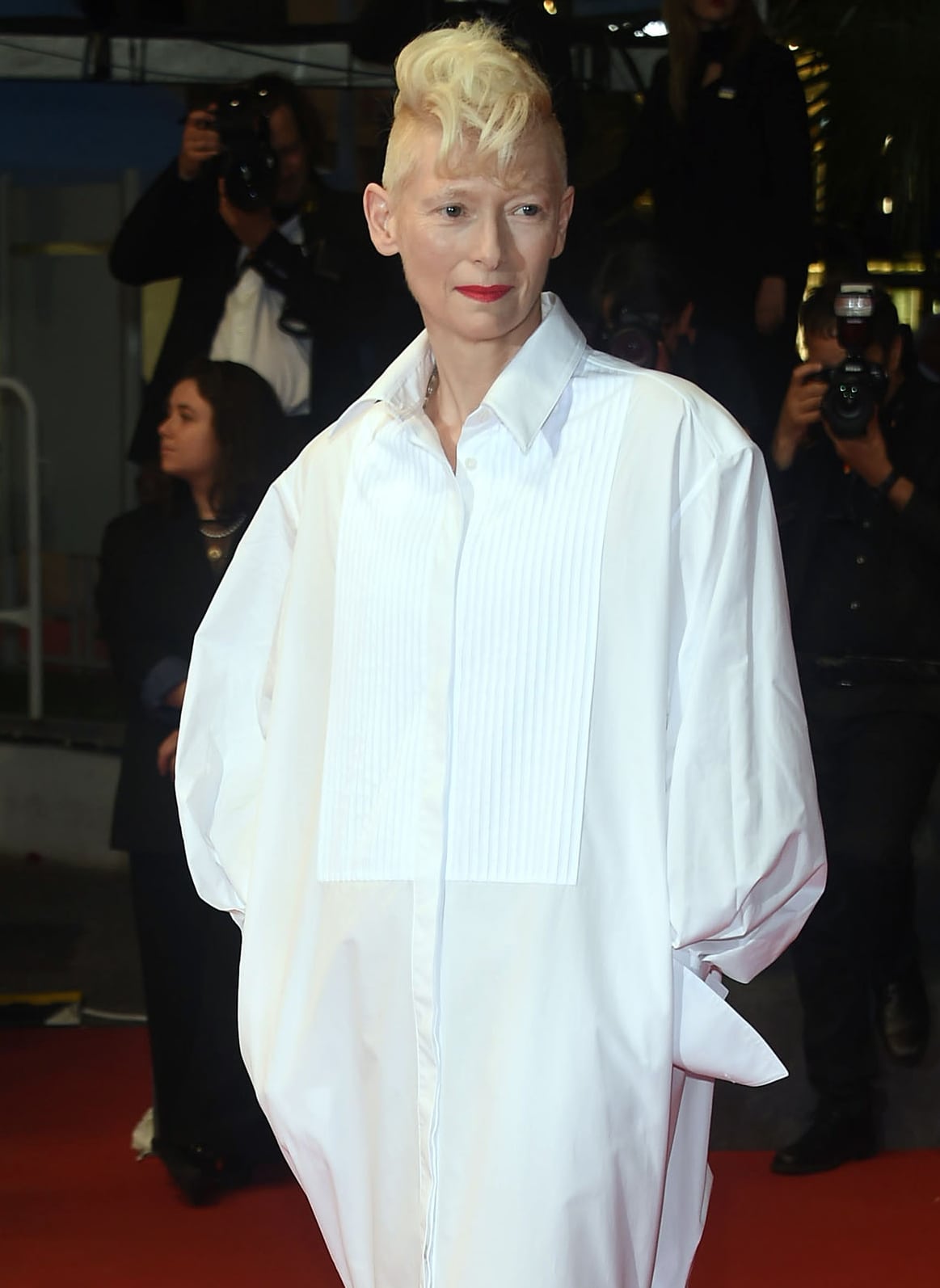 Tilda Swinton's oversized white shirt dress features a pleated front bib and a mermaid-style ruffled hem