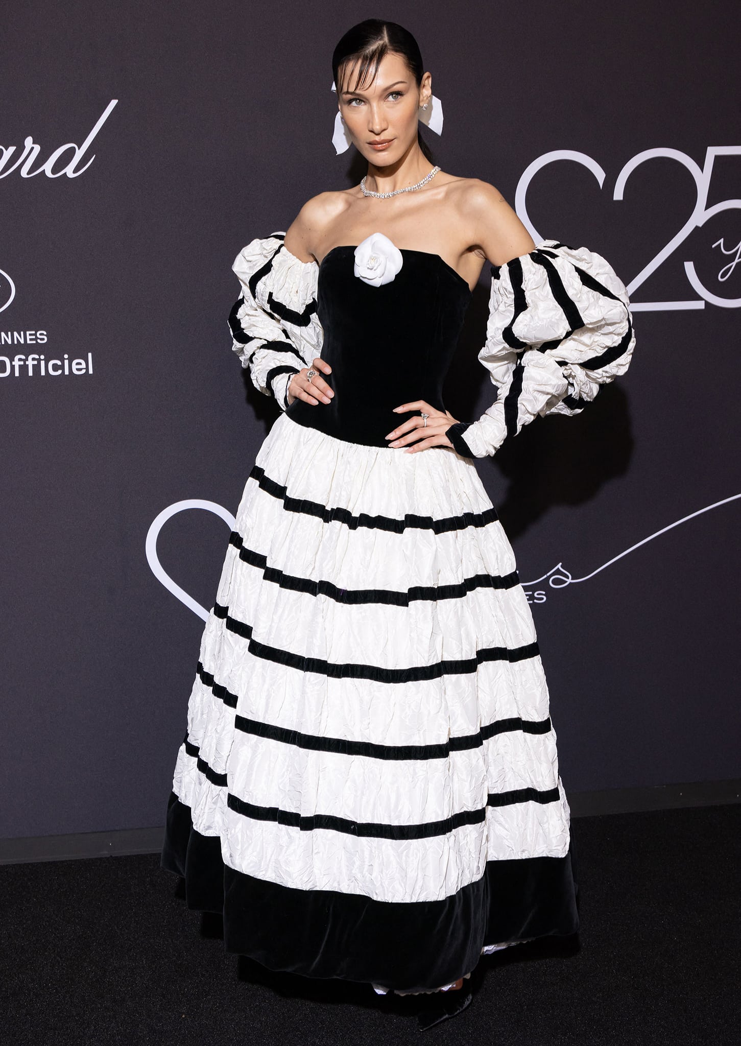 Bella Hadid attends the "Chopard Loves Cinema" gala in a black-and-white Chanel ruffle dress with mutton sleeves at Hotel Martinez on May 25, 2022