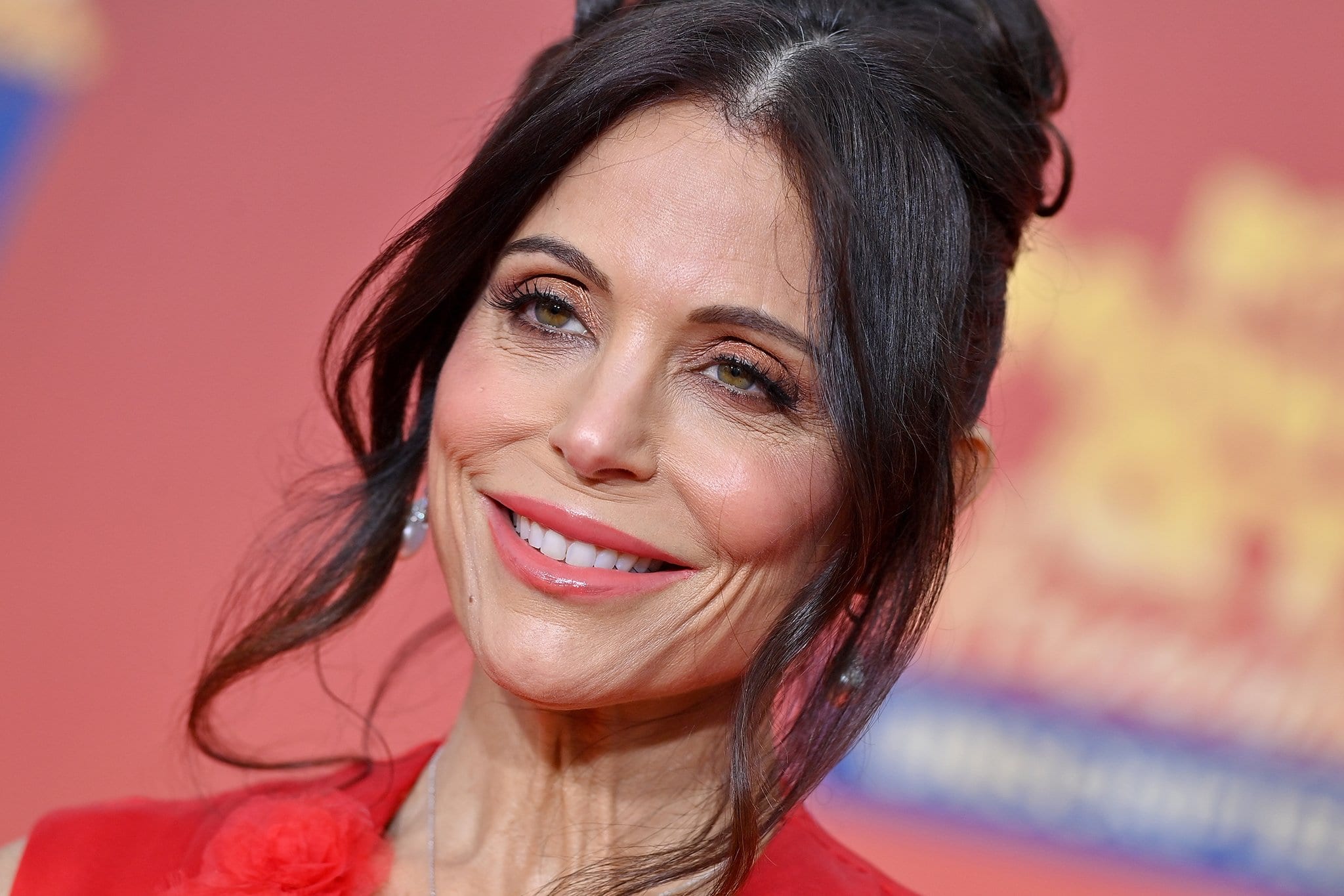 Bethenny Frankel styles her tresses in a messy bun and wears rosy eyeshadow and matching lip gloss