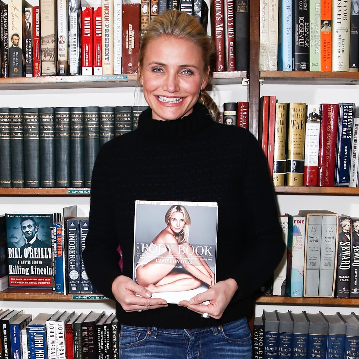 Actress Cameron Diaz holds a copy of her book "The Body Book: The Law of Hunger, the Science of Strength and Other Ways to Love Your Amazing Body"