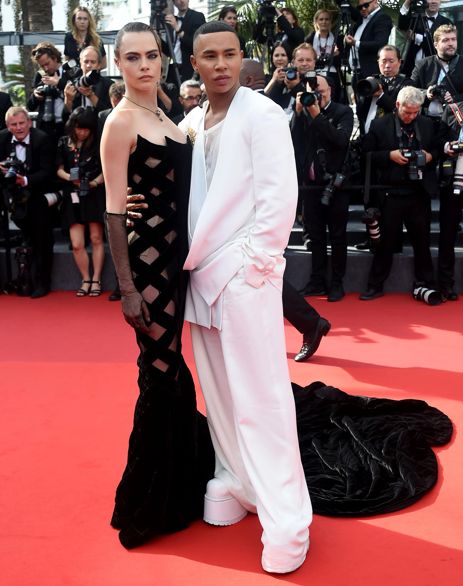 Cara Delevingne pose with Balmain creative director Olivier Rousteing clad in an all-white outfit