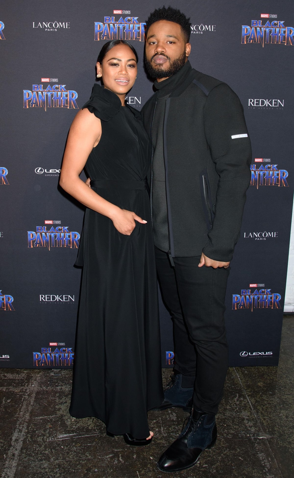 Zinzi Evans stuns in an elegant black gown alongside Black Panther director Ryan Coogler, who keeps it sleek and modern in a dark monochrome ensemble at the Marvel Studios Black Panther Welcome to Wakanda New York Fashion Week Showcase
